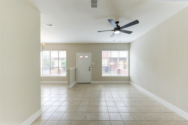 foyer entrance with a healthy amount of sunlight, light tile patterned flooring, and visible vents
