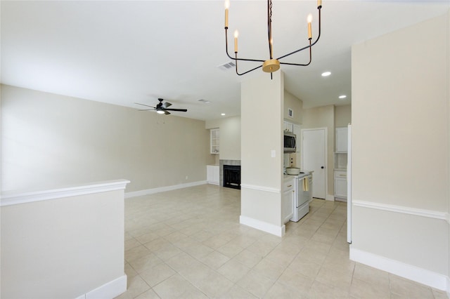 interior space featuring visible vents, a fireplace, light tile patterned floors, ceiling fan with notable chandelier, and recessed lighting