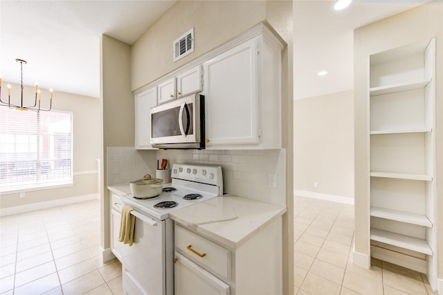 kitchen featuring stainless steel microwave, visible vents, white electric stove, and light tile patterned floors