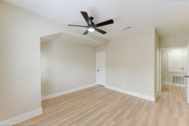 unfurnished room with visible vents, a ceiling fan, and light wood-type flooring