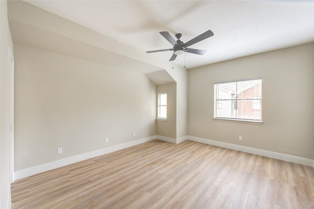 unfurnished room featuring baseboards, a ceiling fan, and light wood-style flooring