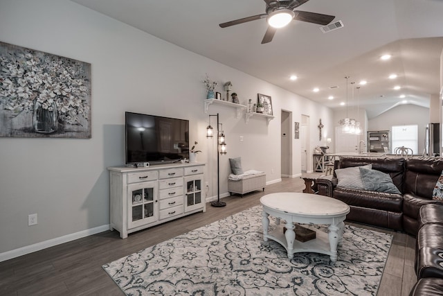 living area with ceiling fan, visible vents, dark wood finished floors, and lofted ceiling