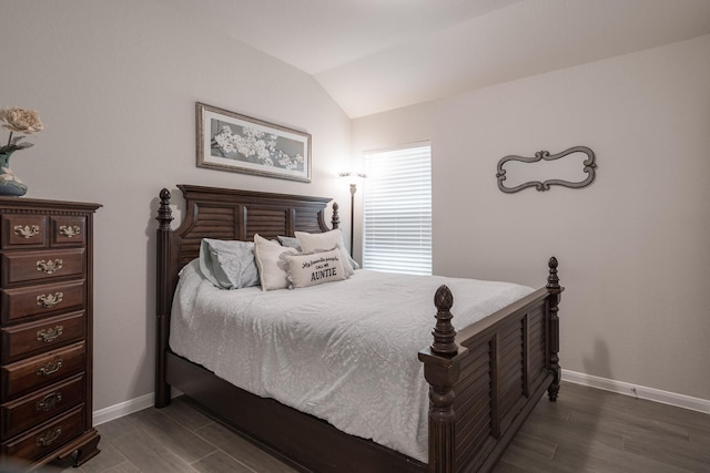 bedroom with baseboards, dark wood-style flooring, and lofted ceiling