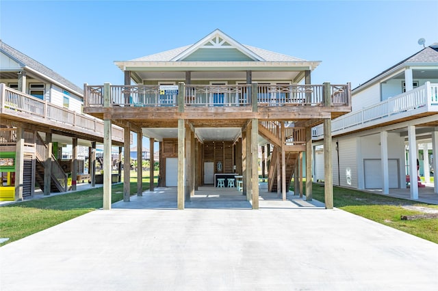beach home with stairs, driveway, and a carport