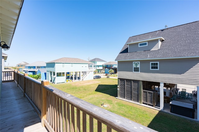 deck with a lawn and a residential view