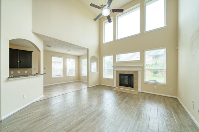 24618 Malca Manor Dr, Katy, TX 77493 - unfurnished living room with a ceiling fan, a high ceiling, plenty of natural light, and baseboards