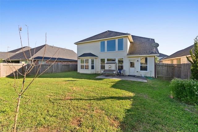 24618 Malca Manor Dr, Katy, TX 77493 - rear view of house featuring a lawn, a fenced backyard, roof with shingles, and a patio
