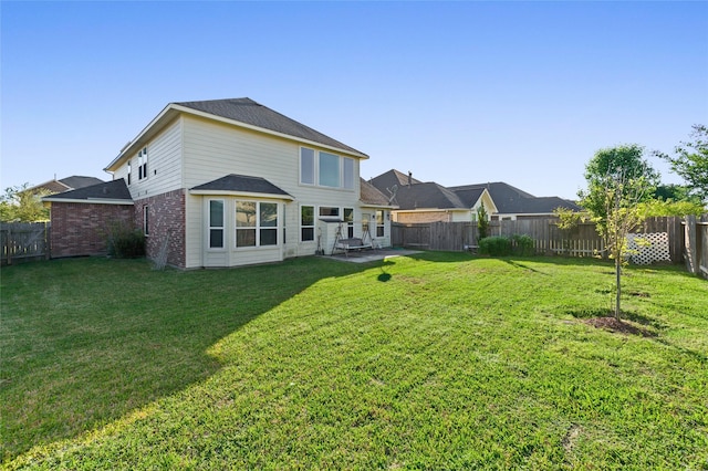 24618 Malca Manor Dr, Katy, TX 77493 - rear view of property with brick siding, a fenced backyard, a yard, and a patio