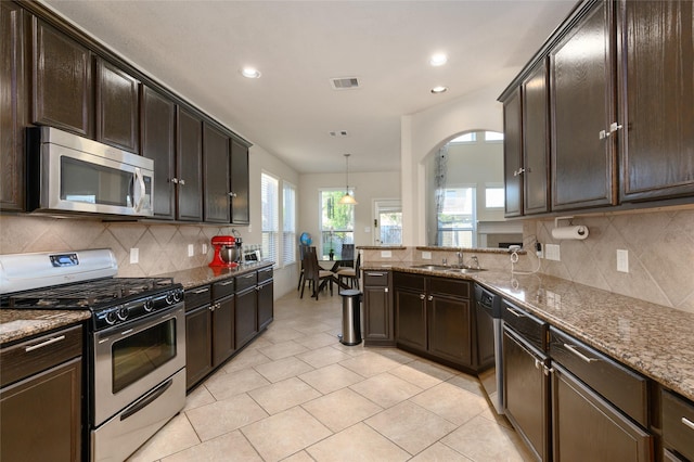 24618 Malca Manor Dr, Katy, TX 77493 - kitchen with visible vents, recessed lighting, a sink, stone counters, and stainless steel appliances