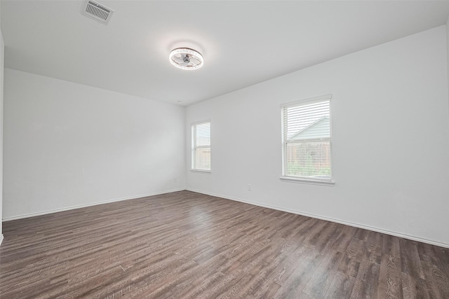 12518 Pelican Bay Dr, Houston, TX 77038 - unfurnished room with baseboards, dark wood-type flooring, and visible vents