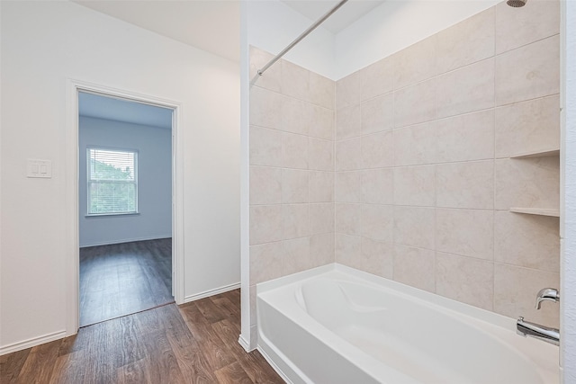 12518 Pelican Bay Dr, Houston, TX 77038 - bathroom with baseboards, wood finished floors, and tub / shower combination