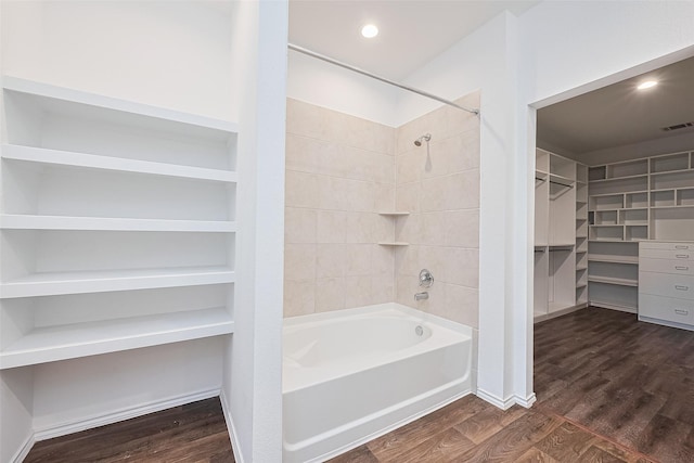 12518 Pelican Bay Dr, Houston, TX 77038 - bathroom featuring a walk in closet, visible vents, tub / shower combination, and wood finished floors
