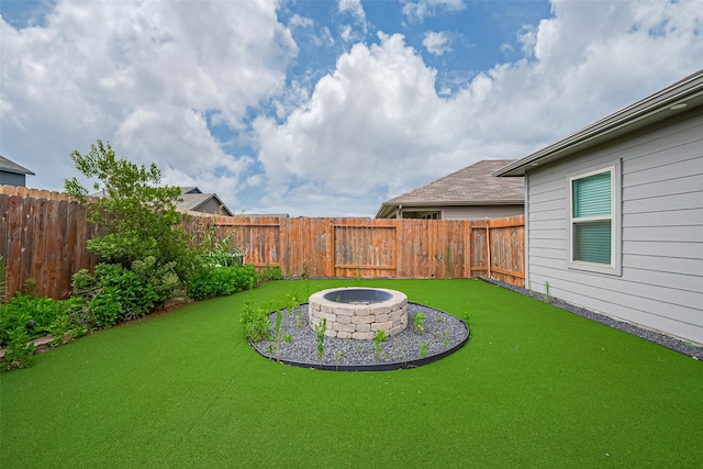 12518 Pelican Bay Dr, Houston, TX 77038 - view of yard with a fenced backyard and an outdoor fire pit