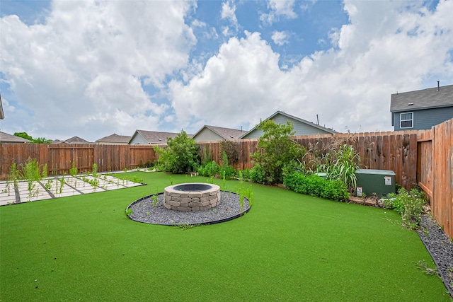 12518 Pelican Bay Dr, Houston, TX 77038 - view of yard featuring a fenced backyard and a fire pit