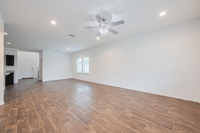 12518 Pelican Bay Dr, Houston, TX 77038 - empty room with baseboards, a ceiling fan, light wood finished floors, and visible vents