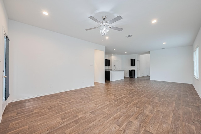 12518 Pelican Bay Dr, Houston, TX 77038 - unfurnished living room with ceiling fan, light wood finished floors, recessed lighting, baseboards, and visible vents