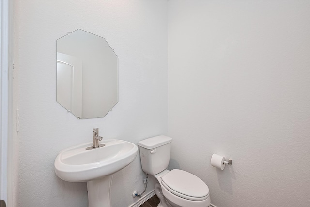 12518 Pelican Bay Dr, Houston, TX 77038 - half bath with toilet, a sink, and wood finished floors