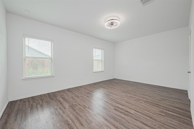 12518 Pelican Bay Dr, Houston, TX 77038 - empty room featuring visible vents, baseboards, and wood finished floors