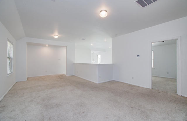 unfurnished room featuring carpet floors, baseboards, and visible vents