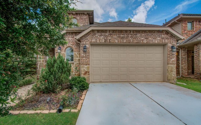 3730 Bach St, Iowa Colony, TX 77583 - view of front of property featuring brick siding, driveway, a garage, and stone siding