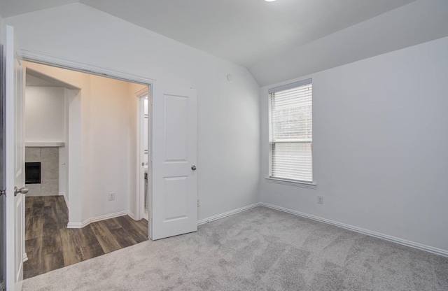 3730 Bach St, Iowa Colony, TX 77583 - spare room with lofted ceiling, carpet floors, and a fireplace
