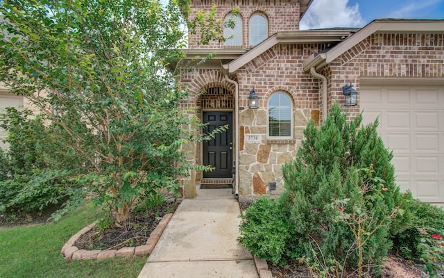 3730 Bach St, Iowa Colony, TX 77583 - entrance to property featuring an attached garage, brick siding, and stone siding