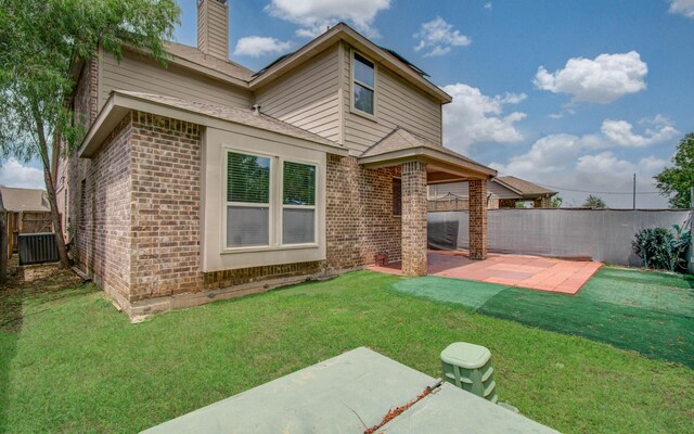 3730 Bach St, Iowa Colony, TX 77583 - back of house with brick siding, a patio area, a fenced backyard, and a chimney