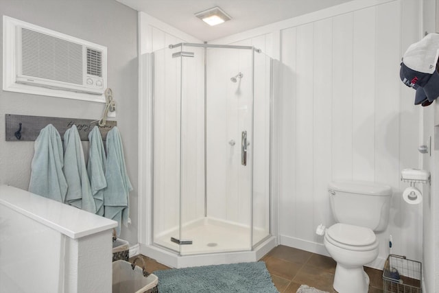 307 N St, Baytown, TX 77520 - bathroom with tile patterned flooring, an AC wall unit, toilet, baseboards, and a stall shower