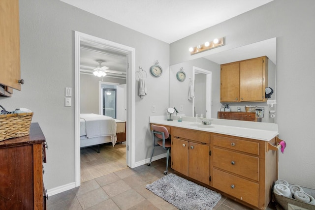 307 N St, Baytown, TX 77520 - bathroom with a ceiling fan, tile patterned flooring, vanity, baseboards, and ensuite bathroom