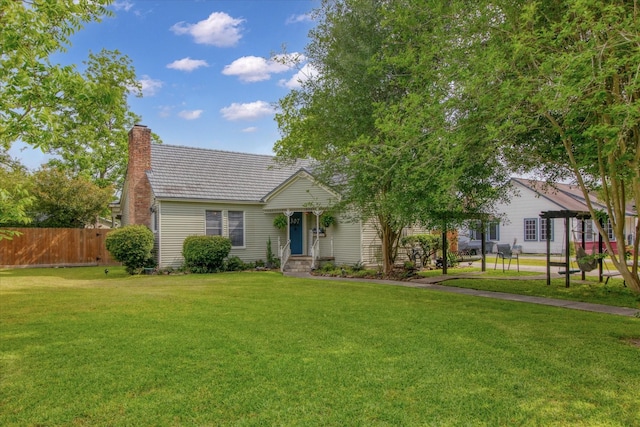 307 N St, Baytown, TX 77520 - single story home with a front lawn, fence, and a chimney