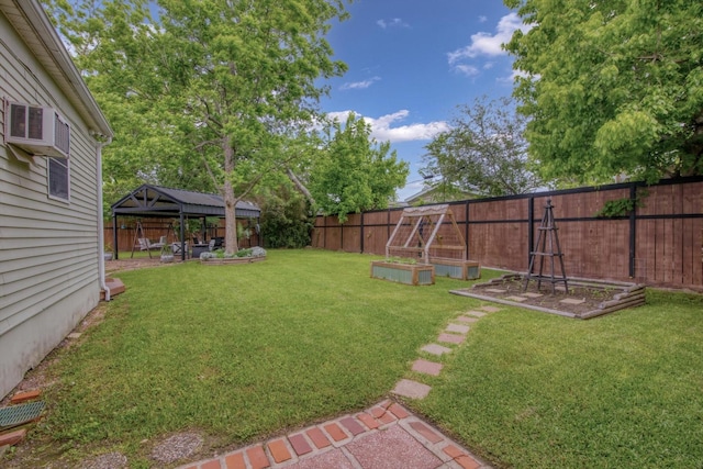 307 N St, Baytown, TX 77520 - view of yard featuring a fenced backyard, a gazebo, and a vegetable garden