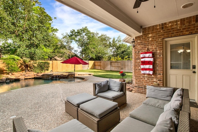 view of patio / terrace with ceiling fan, an outdoor hangout area, a fenced backyard, and an in ground hot tub