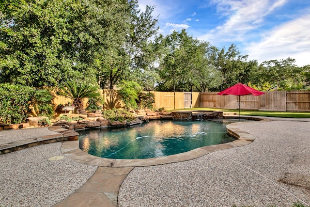 view of swimming pool featuring a fenced in pool, a fenced backyard, and a hot tub