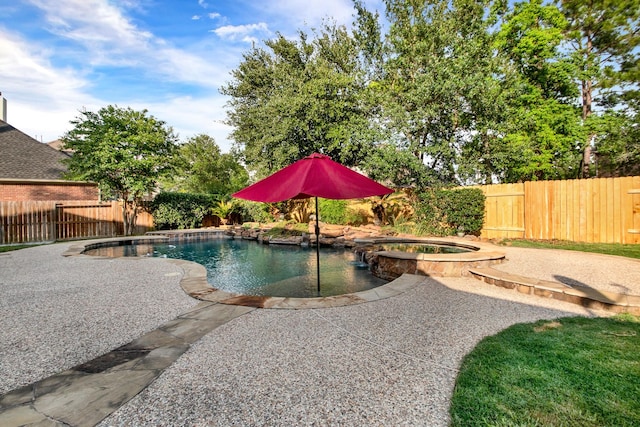 view of swimming pool featuring a patio, a pool with connected hot tub, and a fenced backyard