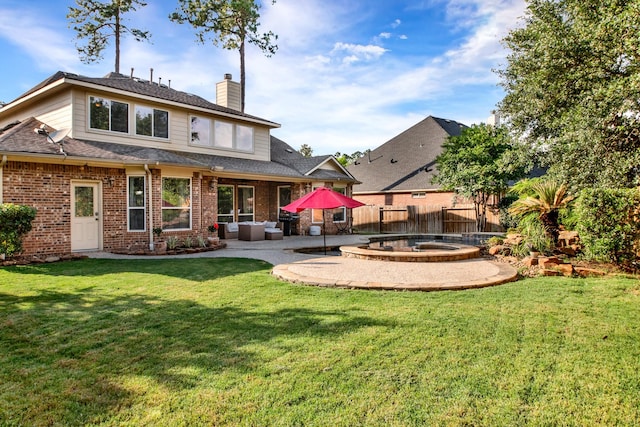 back of house with a lawn, fence, a chimney, and a patio area