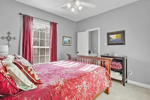 carpeted bedroom featuring baseboards and a ceiling fan
