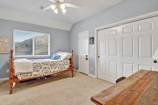 bedroom with a ceiling fan, baseboards, light carpet, and vaulted ceiling