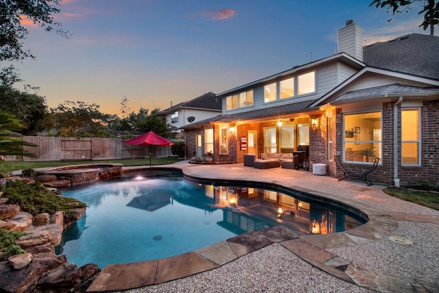 view of swimming pool featuring a pool with connected hot tub, a patio area, fence, and an outdoor hangout area