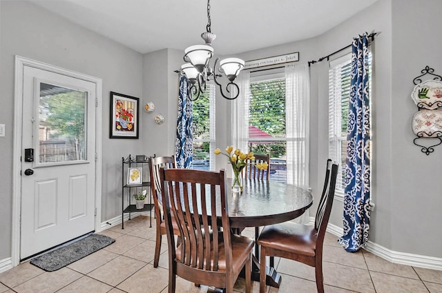 dining room featuring baseboards, light tile patterned floors, and a notable chandelier
