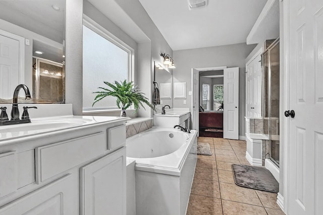bathroom featuring a shower stall, a tub with jets, a sink, tile patterned floors, and connected bathroom