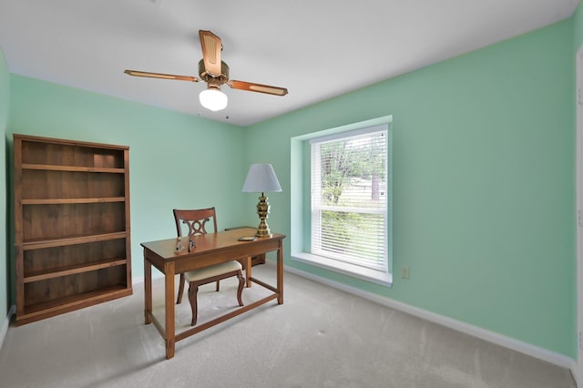office space featuring baseboards, carpet, and a ceiling fan