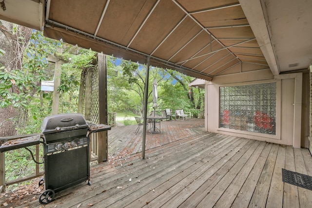 deck with a grill and outdoor dining space