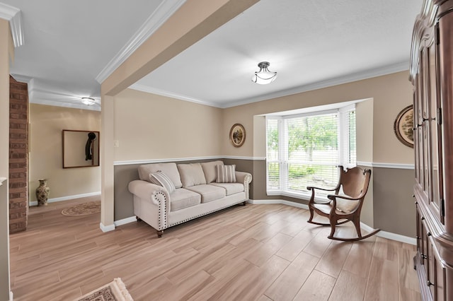 living room with baseboards, light wood-style flooring, and crown molding