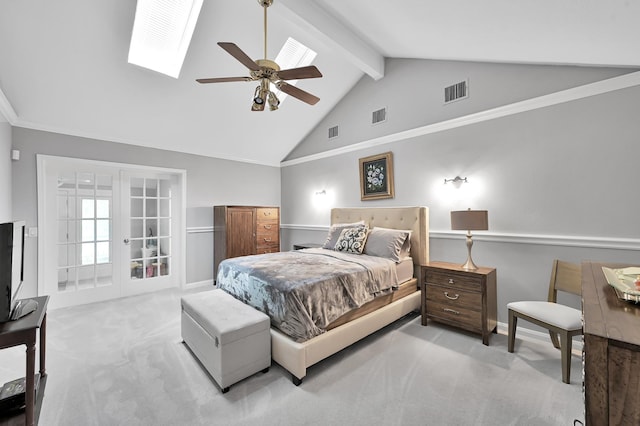 carpeted bedroom featuring beamed ceiling, a skylight, and visible vents