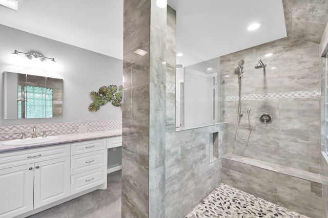 bathroom featuring vanity, recessed lighting, and tiled shower