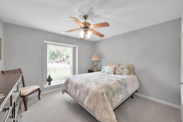bedroom featuring baseboards, ceiling fan, and light colored carpet