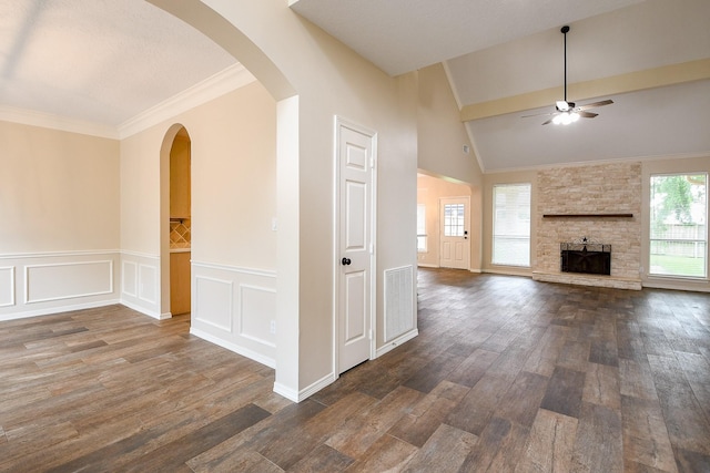 241 Blue Hill Dr, Montgomery, TX 77356 - unfurnished living room featuring a fireplace, ceiling fan, dark wood-style floors, a wainscoted wall, and arched walkways