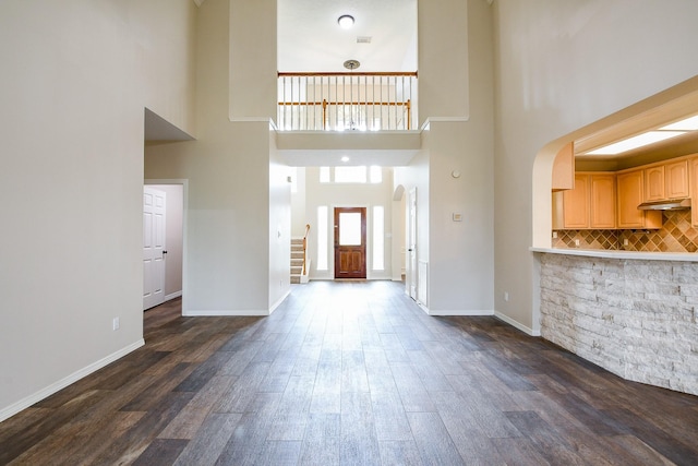 241 Blue Hill Dr, Montgomery, TX 77356 - entryway featuring dark wood-style flooring, baseboards, a high ceiling, stairway, and arched walkways