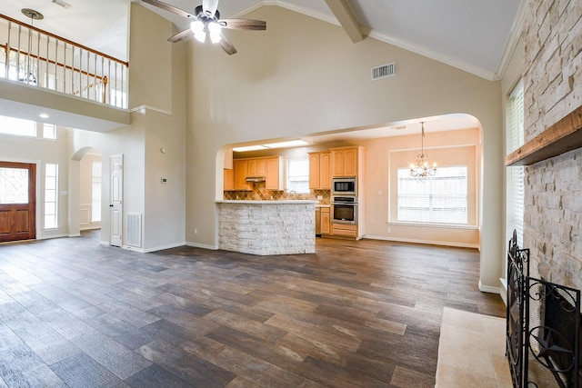 241 Blue Hill Dr, Montgomery, TX 77356 - unfurnished living room featuring visible vents, arched walkways, high vaulted ceiling, ceiling fan with notable chandelier, and dark wood-style floors
