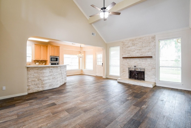 241 Blue Hill Dr, Montgomery, TX 77356 - unfurnished living room with dark wood-style flooring, high vaulted ceiling, a stone fireplace, ceiling fan with notable chandelier, and baseboards